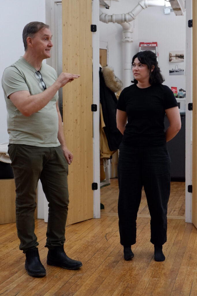 Marc Audette explaining an exercise in the workshop facing the model, Alexane Couture in the studio.