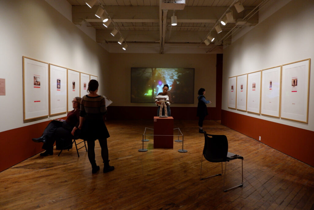 Participants observing artworks in the gallery as part of the workshop.